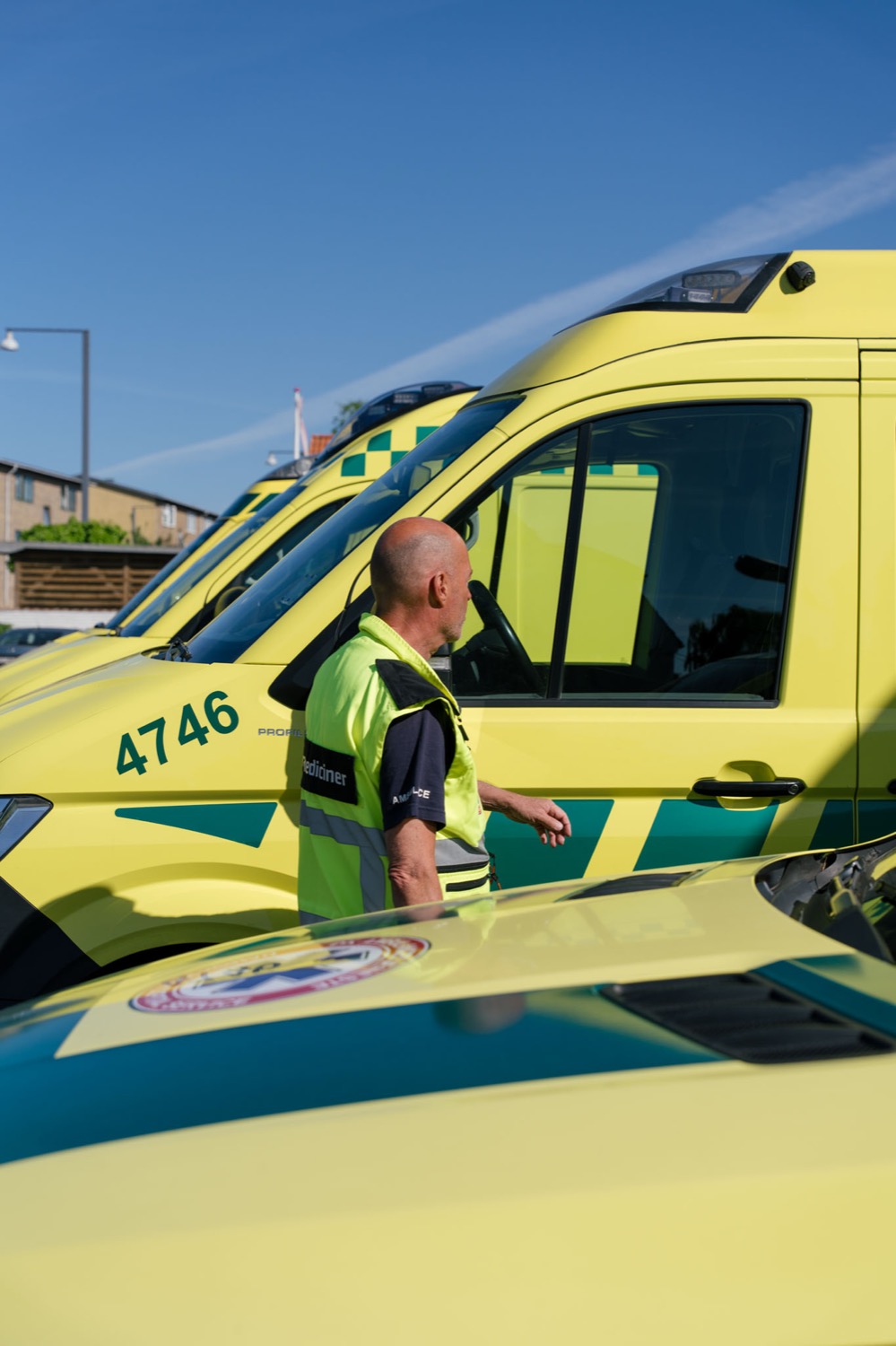 Paramedic by the ambulances in front of the base